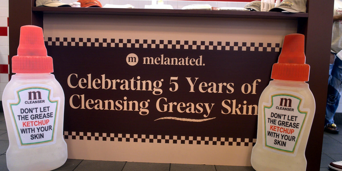 “Celebrating 5 Years of Cleansing Greasy Skin” banner flanked by giant cleanser bottles