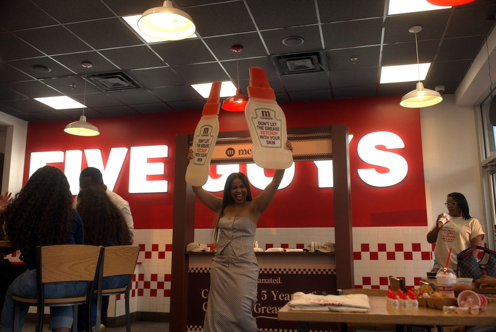 Guest holding up the anniversary sign