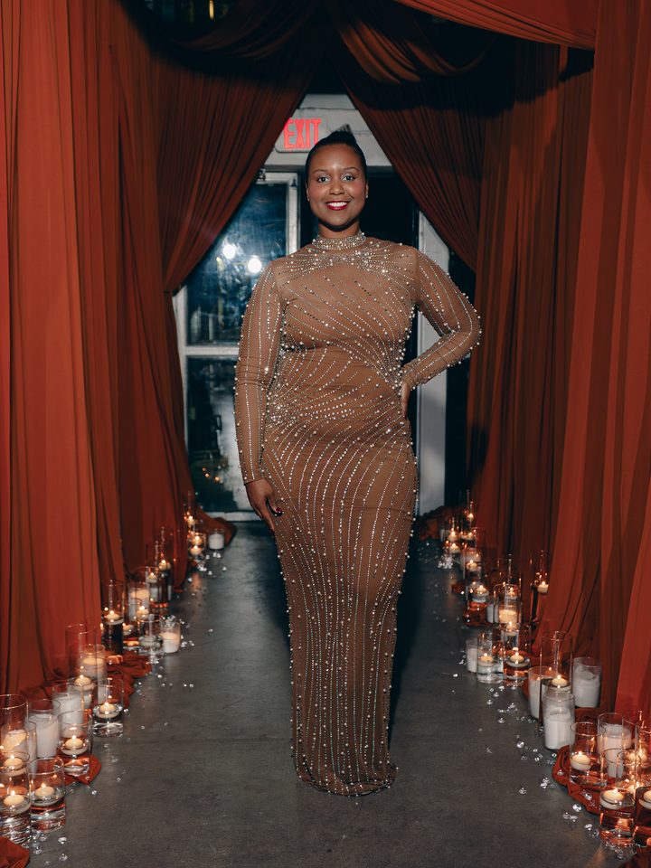 Guest at the candlelit red-curtain entrance