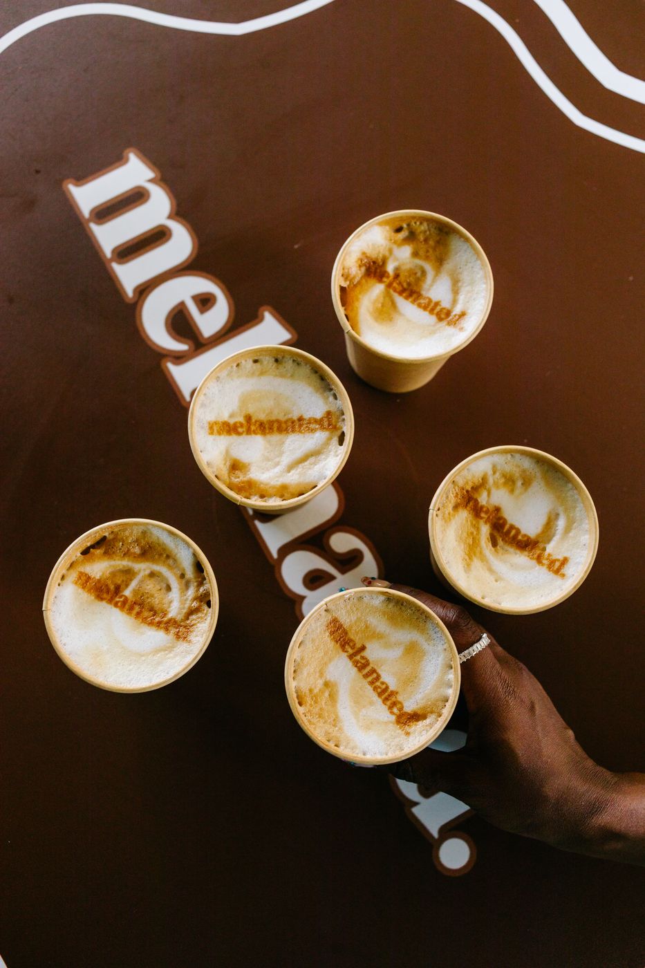Latte art stenciled with the logo