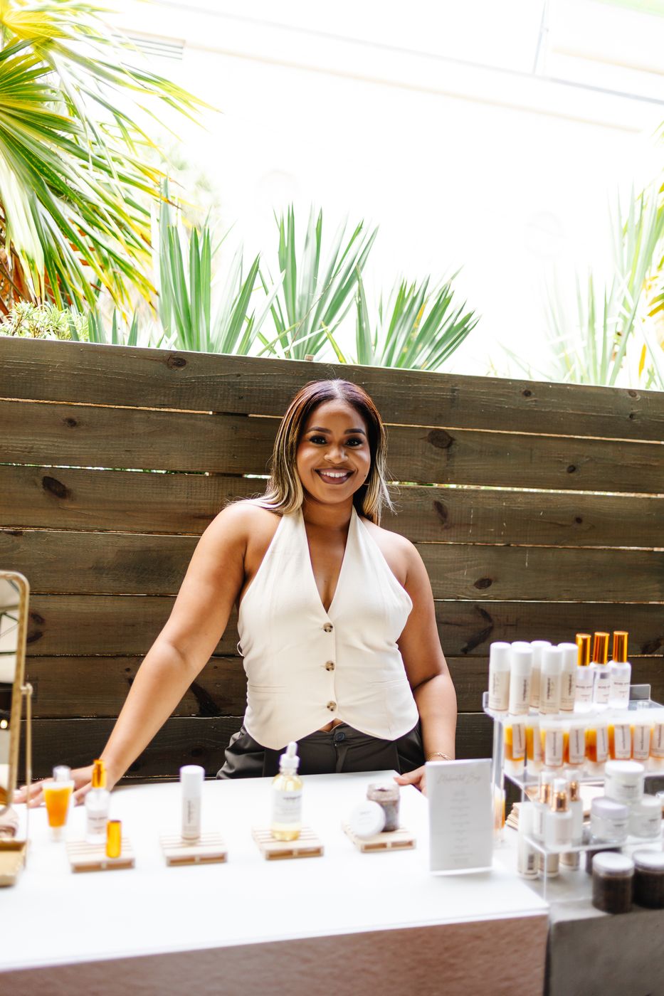 Vendor smiling behind the product table