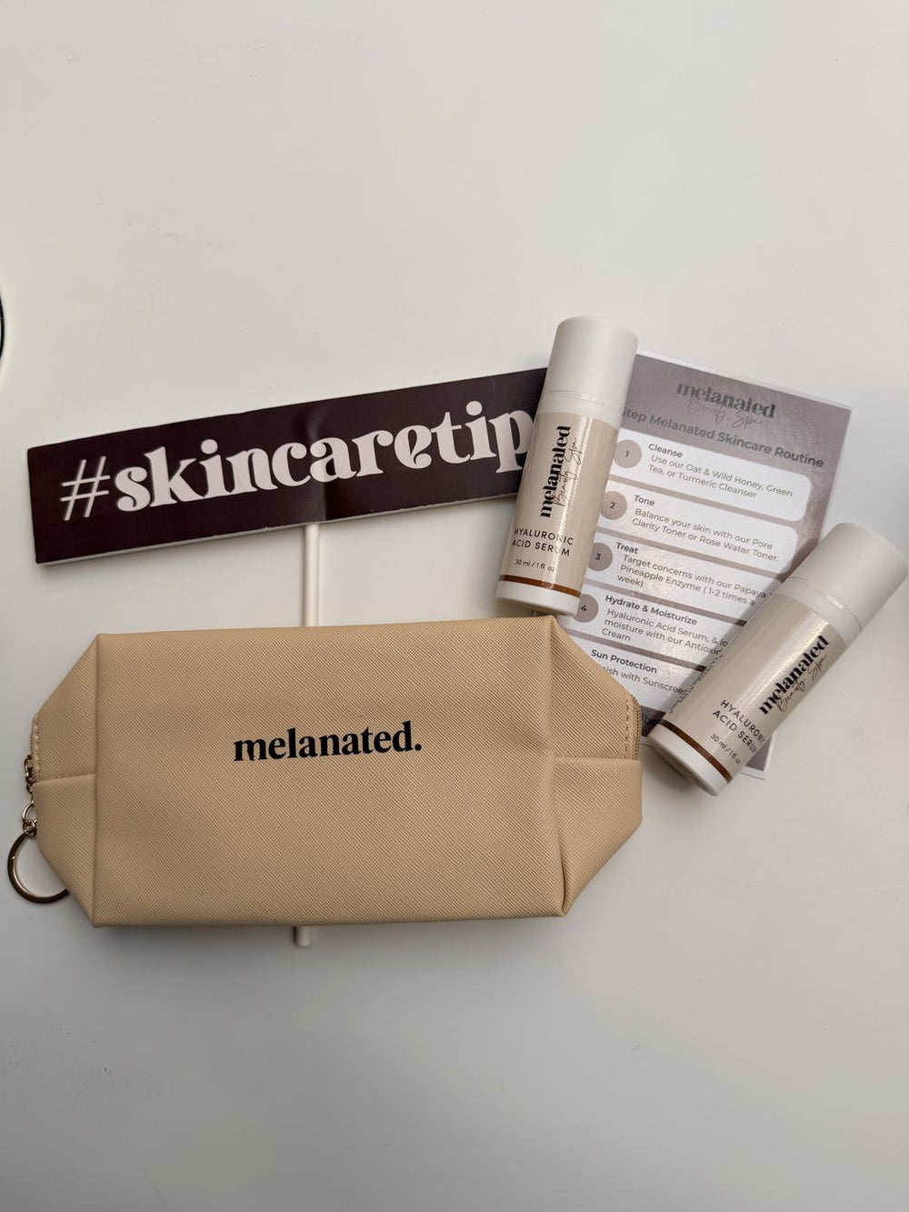 Melanated pouch and minis with a #skincaretips sign