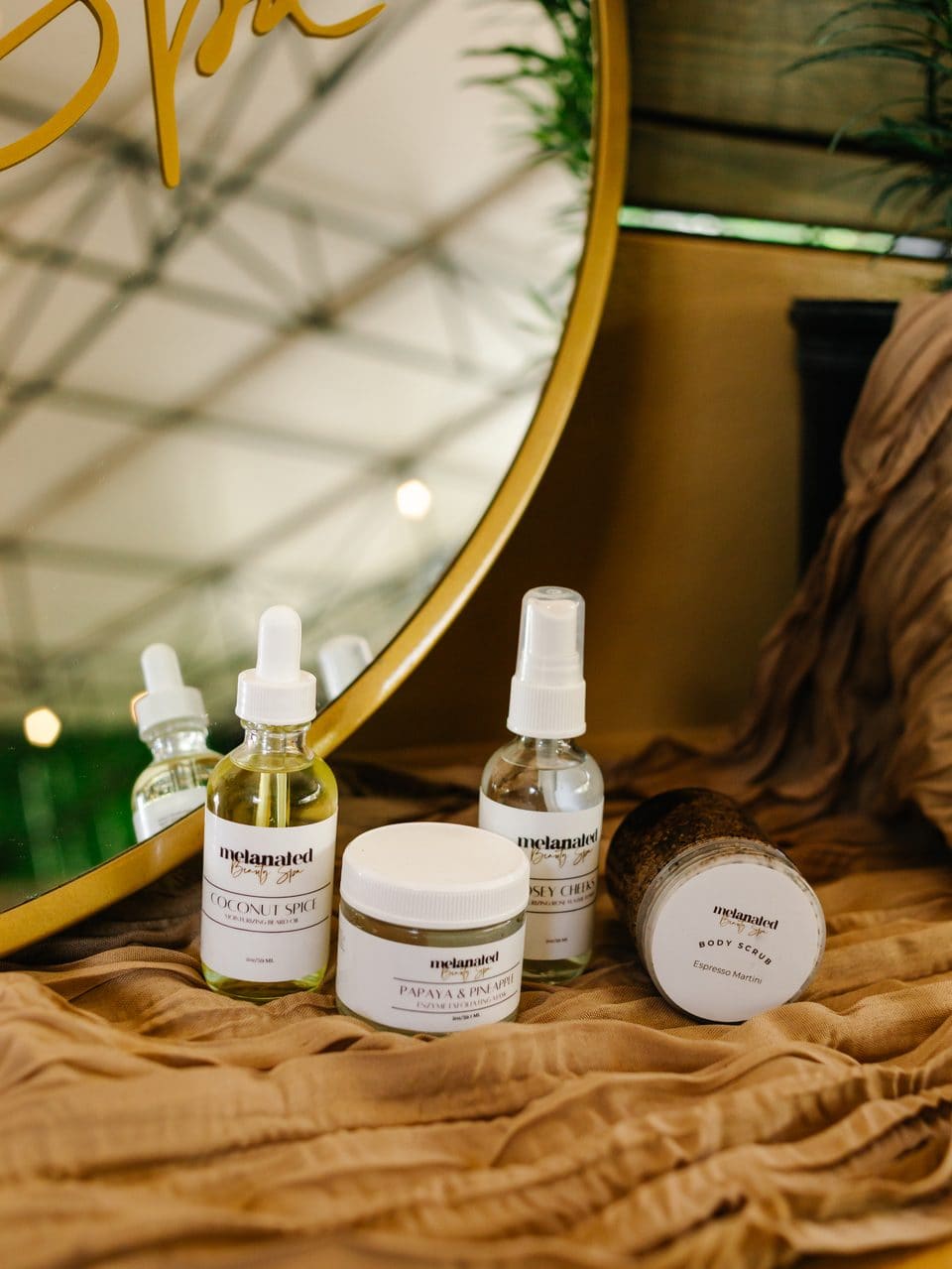 Gold Spa mirror sign above Melanated serums and creams